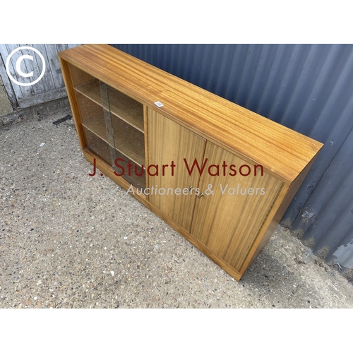 106 - A mid century teak side by side bookcase cupboard