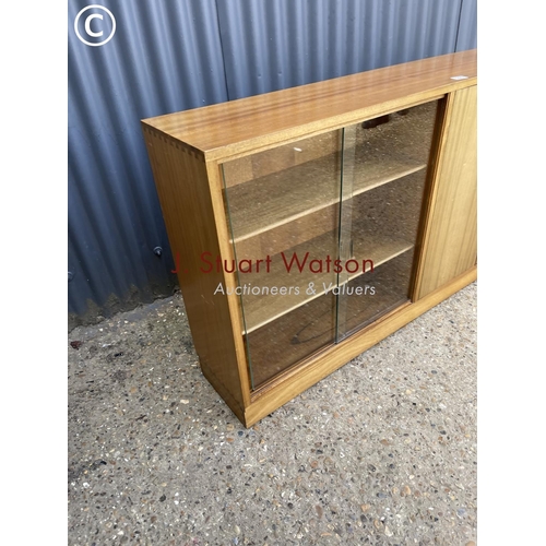 106 - A mid century teak side by side bookcase cupboard