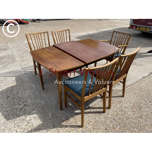 109 - An extending teak dining table by vanson together with five chairs