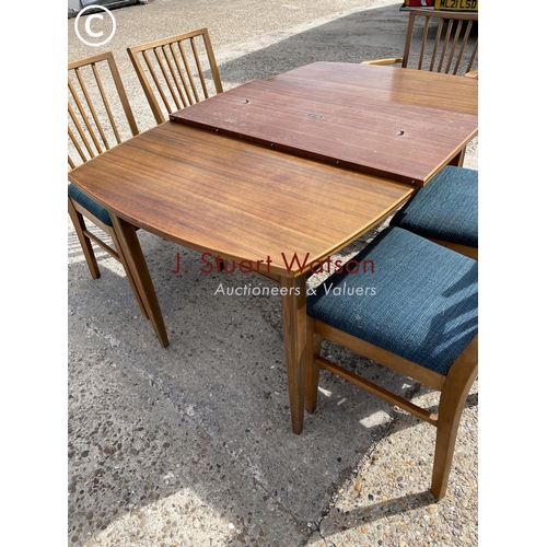 109 - An extending teak dining table by vanson together with five chairs