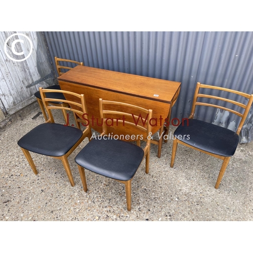 113 - A mid century teak table and four chairs