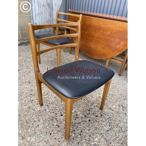 113 - A mid century teak table and four chairs