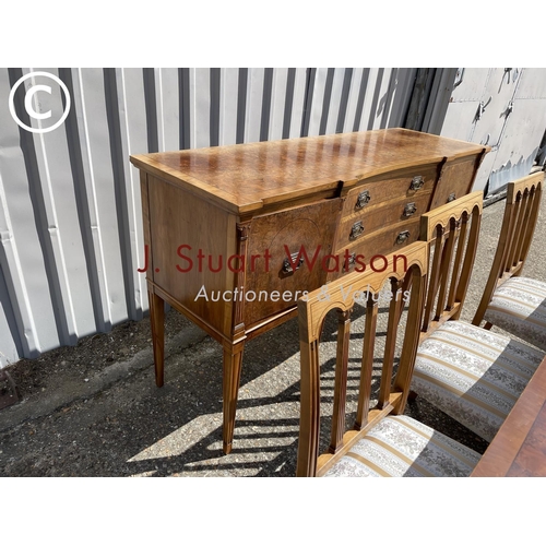 13 - A reproduction walnut dining suite consisting  of a extending table and 8 chairs together with match... 