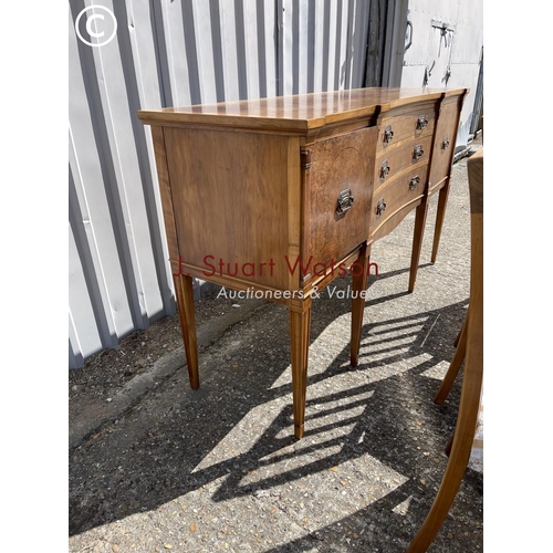 13 - A reproduction walnut dining suite consisting  of a extending table and 8 chairs together with match... 