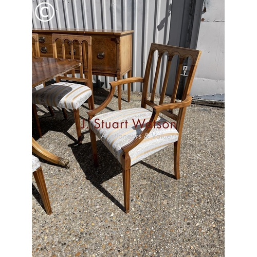 13 - A reproduction walnut dining suite consisting  of a extending table and 8 chairs together with match... 