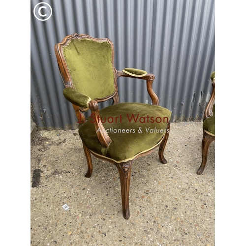 158 - A pair of green upholstered continental elbow chairs