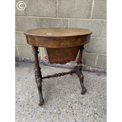 159 - A Victorian oval walnut sewing table