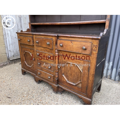 163 - A large antique oak dresser with plate rack top