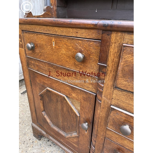 163 - A large antique oak dresser with plate rack top