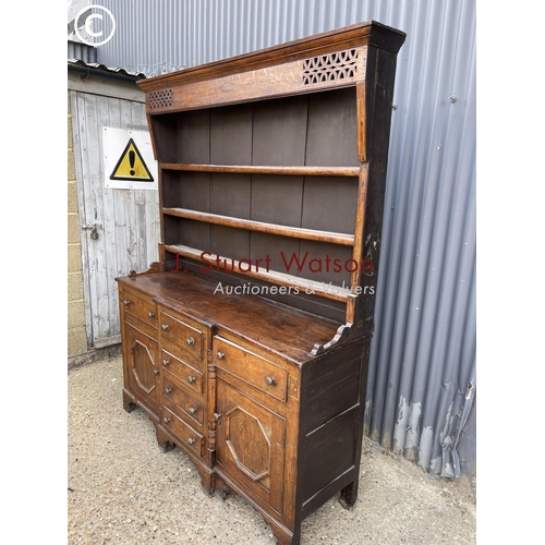 163 - A large antique oak dresser with plate rack top