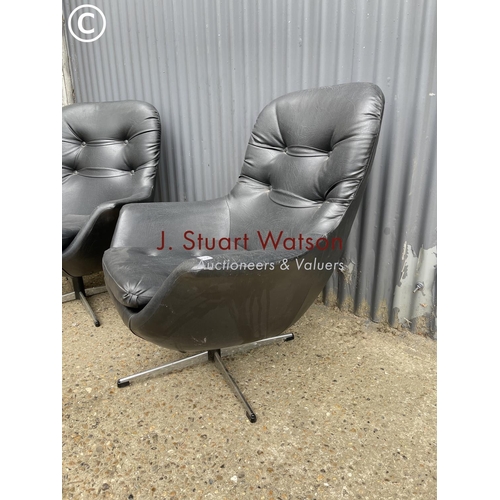 175 - A pair of black vinyl swivel chairs in chrome four point star bases