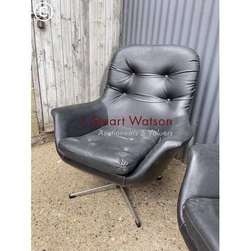 175 - A pair of black vinyl swivel chairs in chrome four point star bases