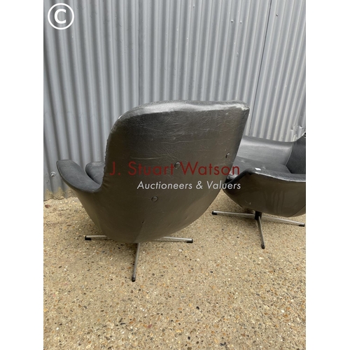 175 - A pair of black vinyl swivel chairs in chrome four point star bases