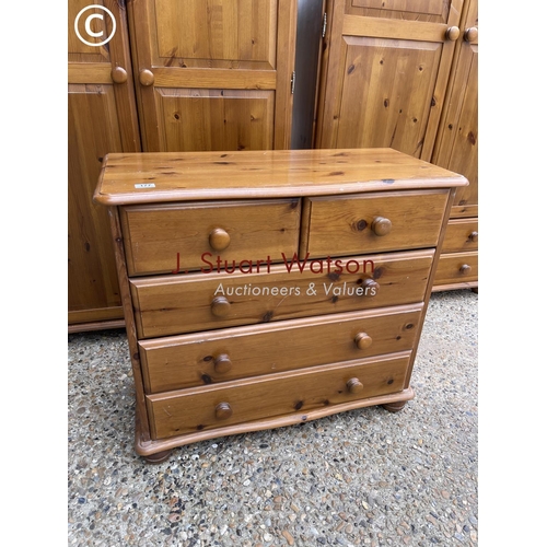 177 - A pine bedroom suite consisting of two double wardrobes together with matching chest of five drawers