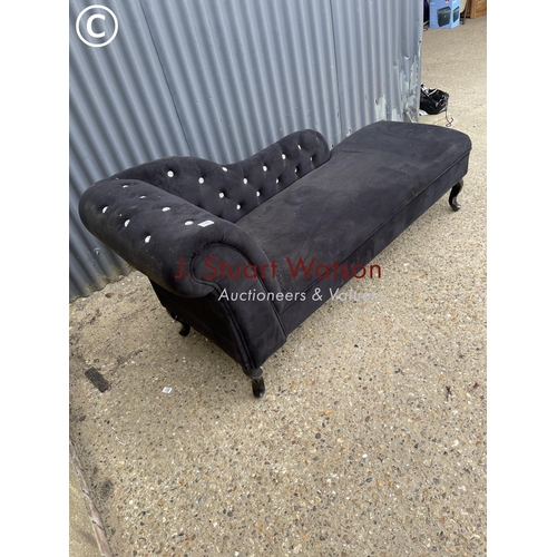 189 - A black upholstered chaise lounge with diamanté detailing