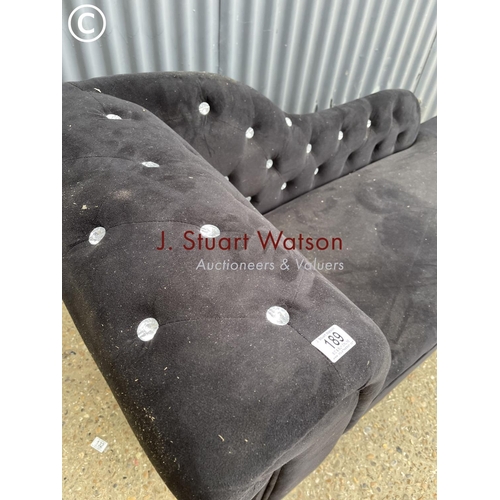 189 - A black upholstered chaise lounge with diamanté detailing