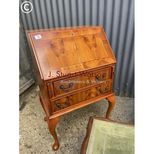 19 - A reproduction yew bureau together with mahogany bedside chest of three and a repro coffee table