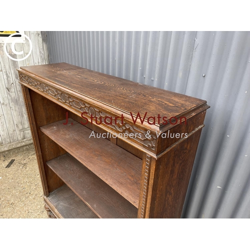 233 - An early 20th century oak open fronted bookcase