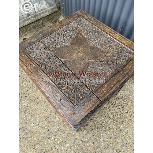 239 - An ornate brass inlaid table on folding base