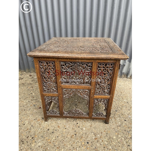 239 - An ornate brass inlaid table on folding base