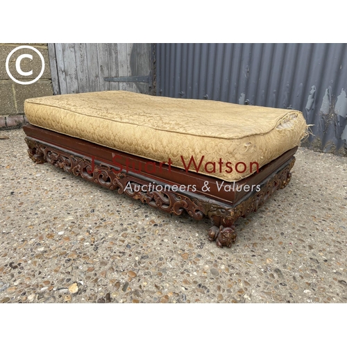 301 - An oriental lacquered and gilt day bed 54x110x20