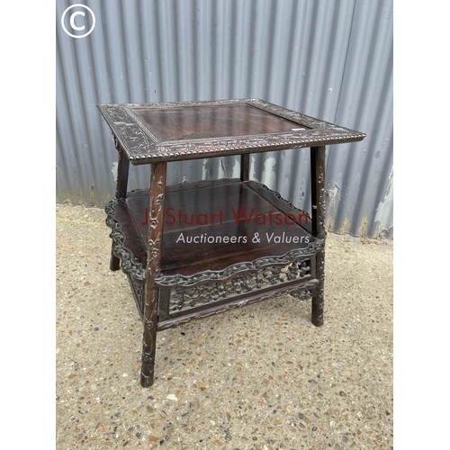 302 - An ornate oriental hardwood side table 64cm square 64cm high