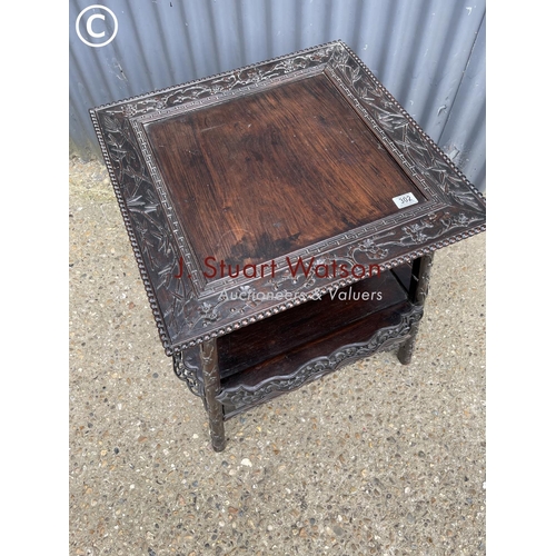 302 - An ornate oriental hardwood side table 64cm square 64cm high