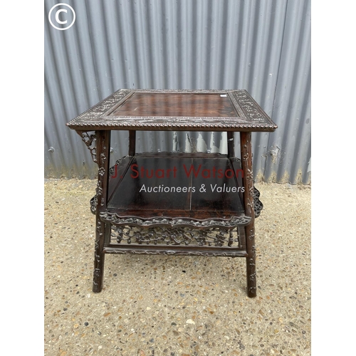 302 - An ornate oriental hardwood side table 64cm square 64cm high