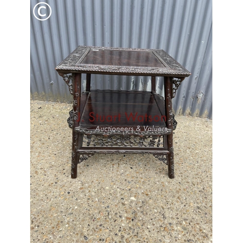 302 - An ornate oriental hardwood side table 64cm square 64cm high