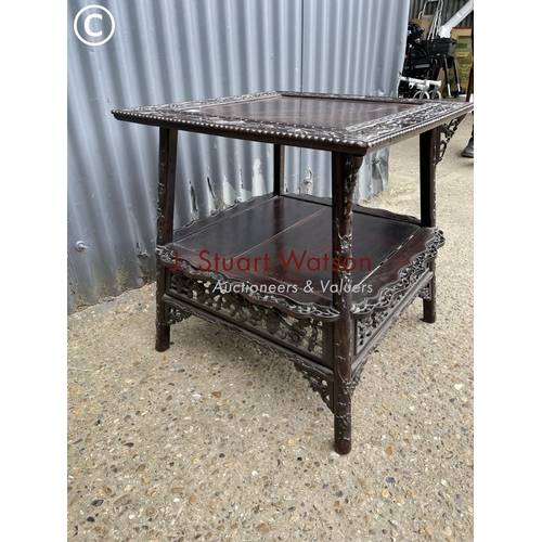 302 - An ornate oriental hardwood side table 64cm square 64cm high