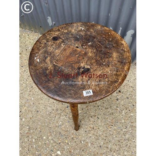 305 - An early elm cricket table 55cm round 65cm high