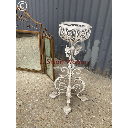 311 - An ornate; metalwork plant stand together with a gold painted metal framed mirror