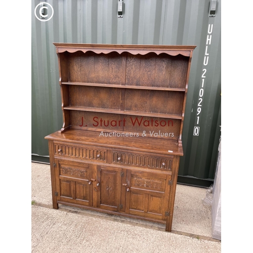 338 - A oak dresser with carved linenfold front