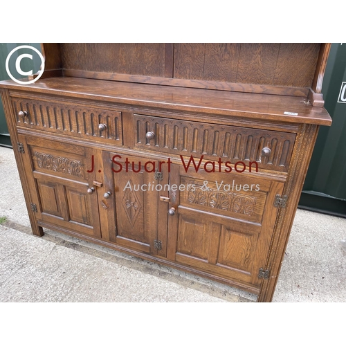 338 - A oak dresser with carved linenfold front