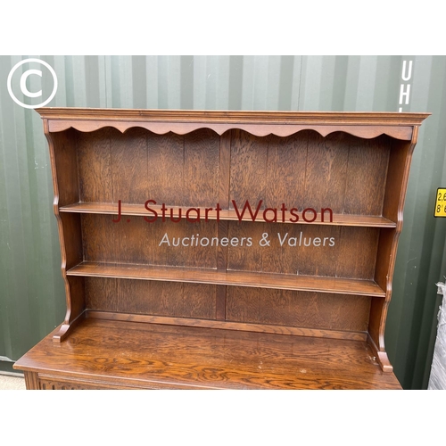 338 - A oak dresser with carved linenfold front