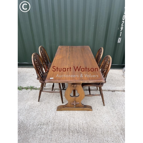 339 - An oak refectory dining table together with four wheelback chairs