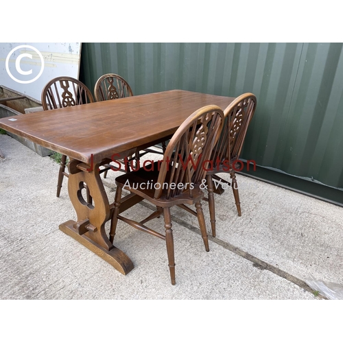 339 - An oak refectory dining table together with four wheelback chairs