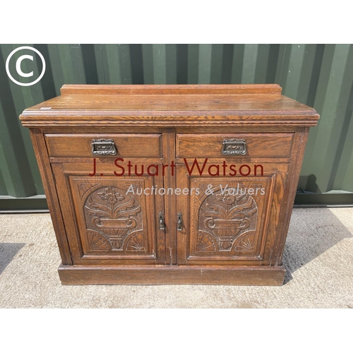 345 - An Edwardian oak two drawer sideboard