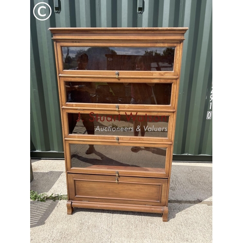 348 - An Edwardian mahogany glazed bookcase with four up and over glass doors