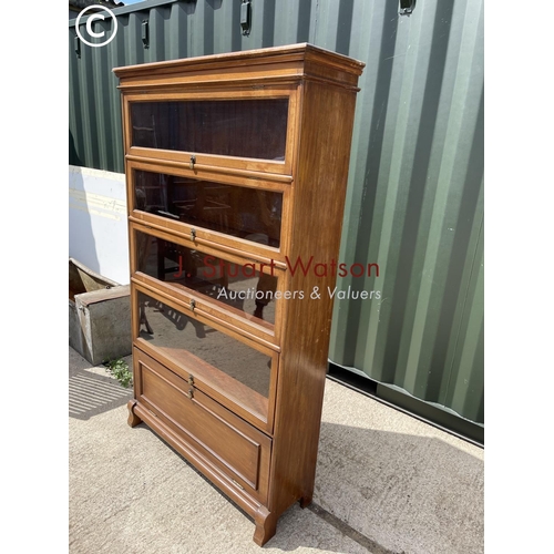 348 - An Edwardian mahogany glazed bookcase with four up and over glass doors