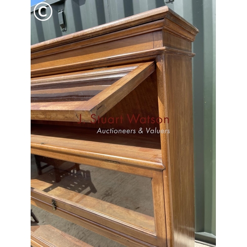 348 - An Edwardian mahogany glazed bookcase with four up and over glass doors