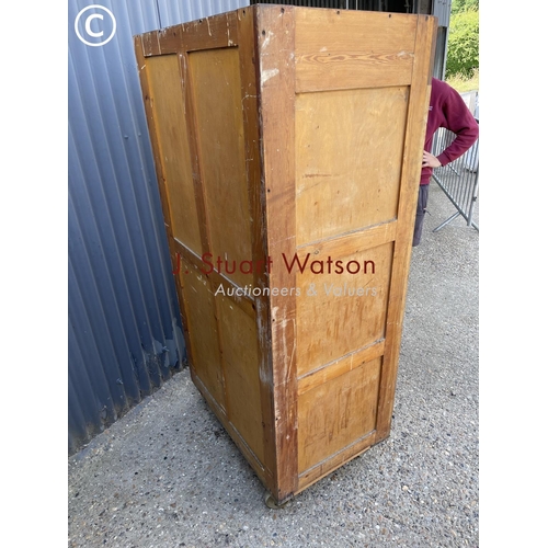 36 - An original vintage bakers 'bun cabinet' tambour front enclosing pine bun drawers. On large castors ... 