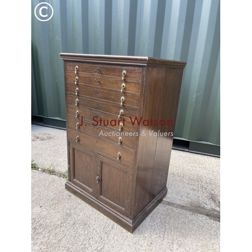 369 - An early 20th century oak collectors chest with six lockable drawers over cupboard 65x48x1 00