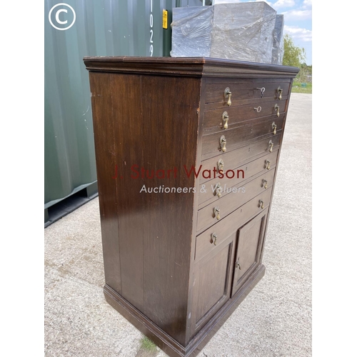 369 - An early 20th century oak collectors chest with six lockable drawers over cupboard 65x48x1 00