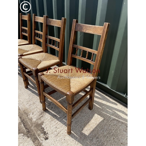 372 - A set of four oak kitchen chairs with rush seats