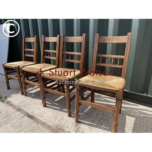 372 - A set of four oak kitchen chairs with rush seats