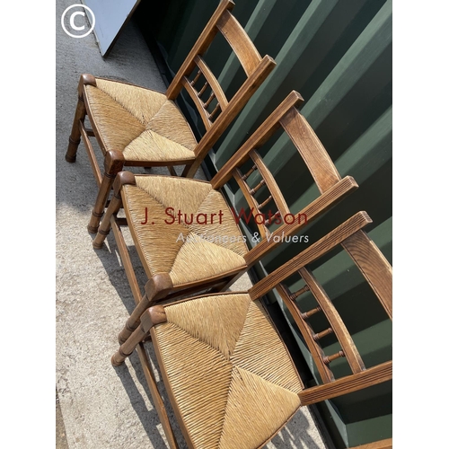 372 - A set of four oak kitchen chairs with rush seats