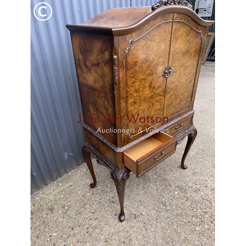 41 - A reproduction walnut drinks cabinet with two drawers