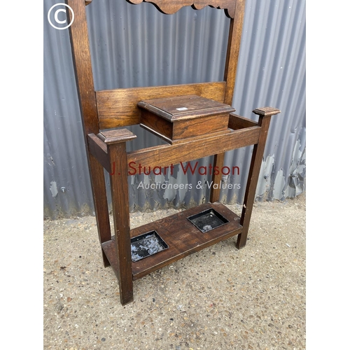 46 - A 20th century oak hall stand with circular mirror back