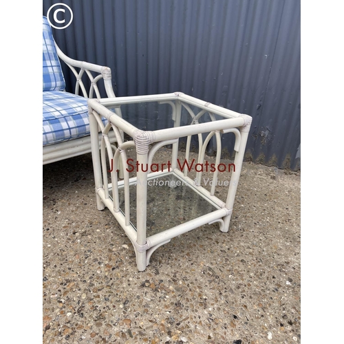 5 - A white bamboo chair together with matching glass top side table